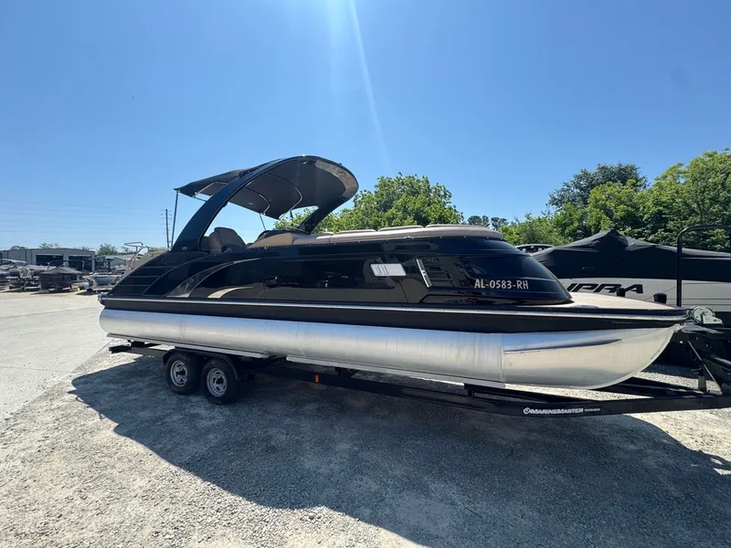 The Image of 2017 Bennington 25QXCWIO pontoon boat on trailer outdoors. - 1