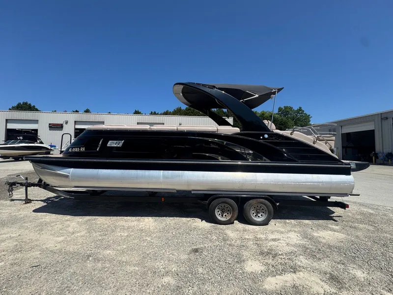 Slide: The Image of 2017 Bennington 25QXCWIO pontoon boat on trailer, sunny day. - 21