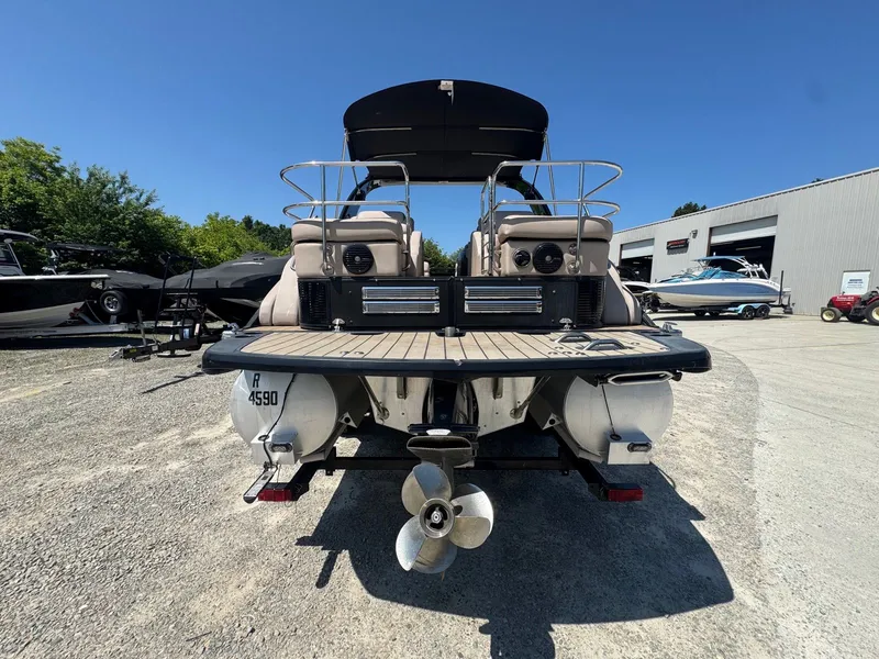 Slide: The Image of Rear view of a 2017 Bennington 25QXCWIO pontoon boat in a parking lot. - 6