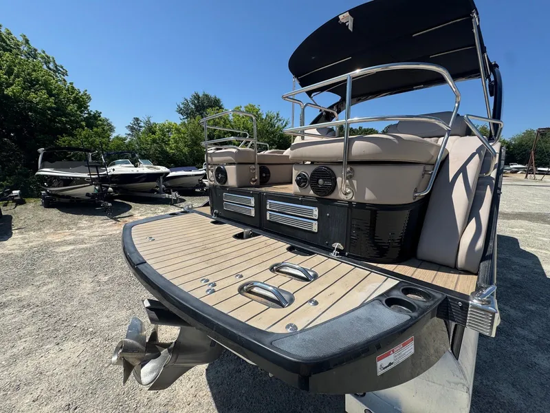 Slide: The Image of 2017 Bennington 25QXCWIO pontoon boat in a parking area. - 7