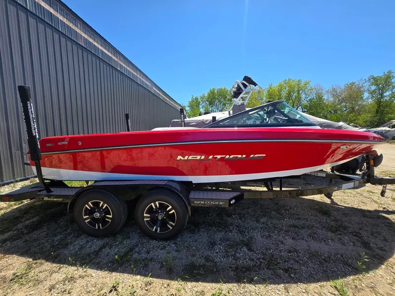 The Image of Red 2019 Nautique 200 boat on trailer, side view. - 1