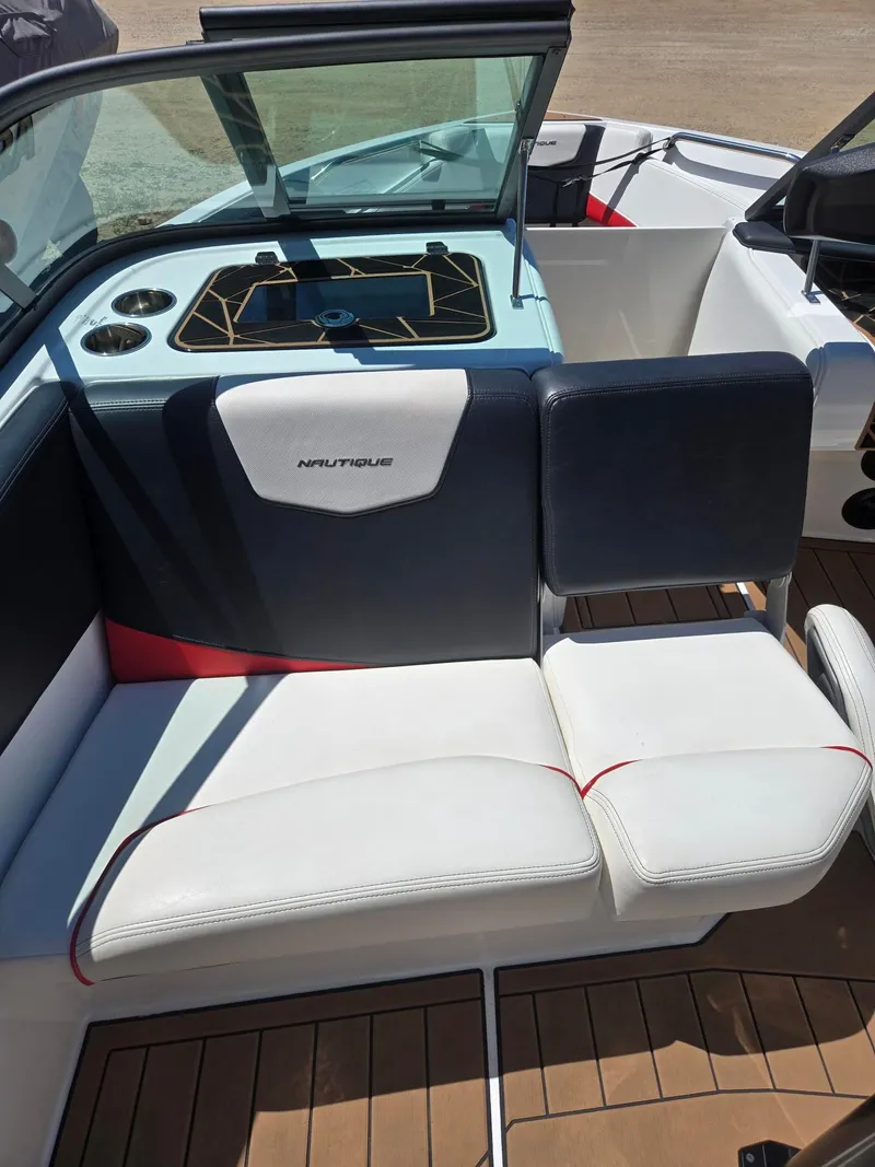 Slide: The Image of Interior of a 2019 Nautique 200 boat with white and blue seating. - 11