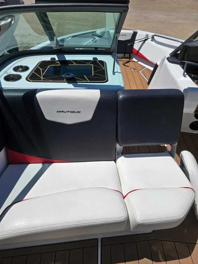 Slide: The Image of Interior of a 2019 Nautique 200 boat with white and blue seating. - 12