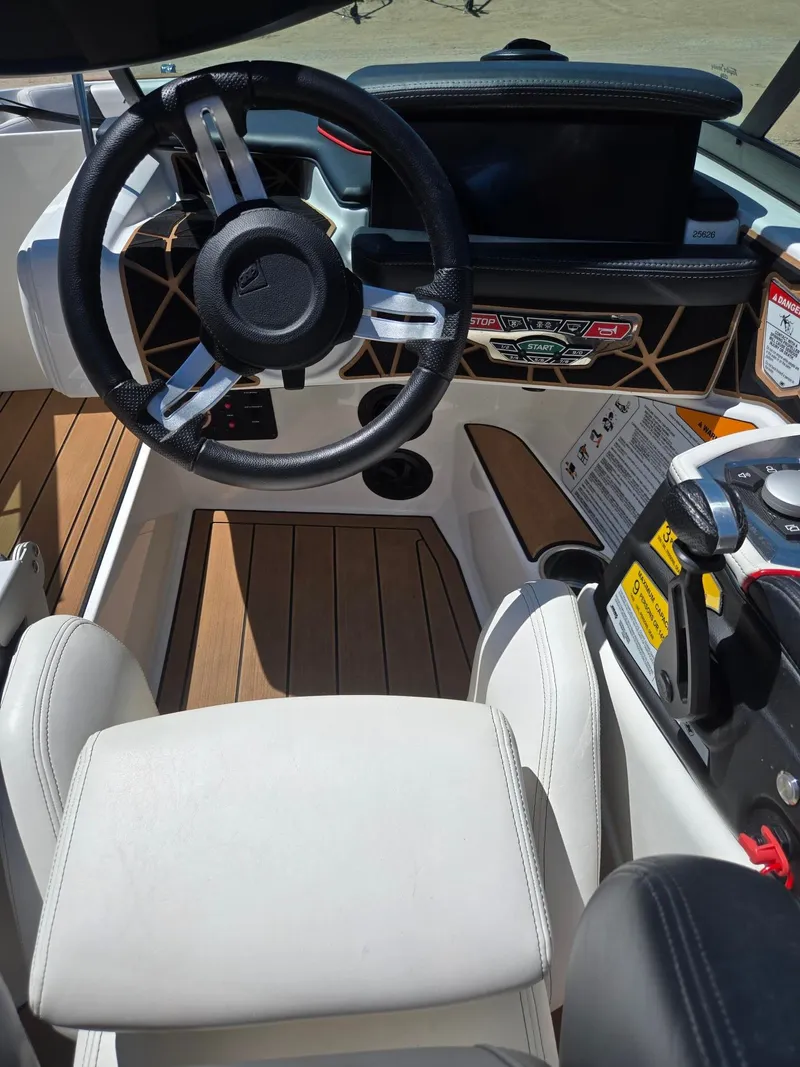 Slide: The Image of Interior of a 2019 Nautique 200 boat with modern steering wheel. - 15