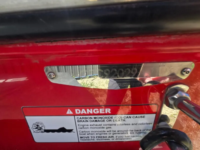 Slide: The Image of Red 2019 Nautique 200 boat with warning label. - 21