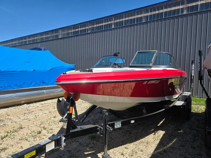 Slide: The Image of Red 2019 Nautique 200 boat on trailer outside warehouse. - 3