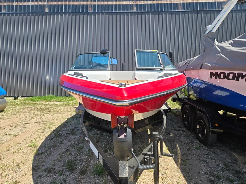Slide: The Image of Red 2019 Nautique 200 boat parked on trailer. - 5