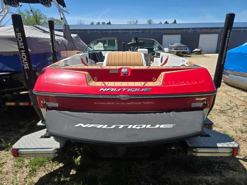 Slide: The Image of Red 2019 Nautique 200 boat parked on a trailer. - 8