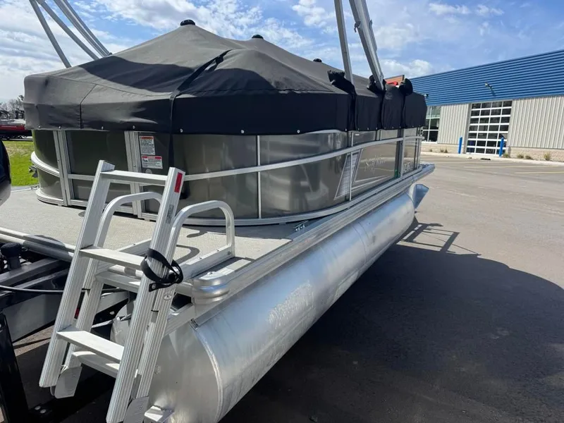 Slide: The Image of 2021 SunCatcher Vista 16 pontoon boat with black canopy and ladder. - 5