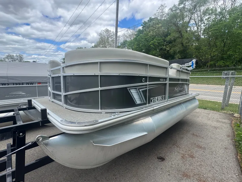 The Image of 2021 SunCatcher Vista 16 pontoon boat on trailer, cloudy sky. - 1