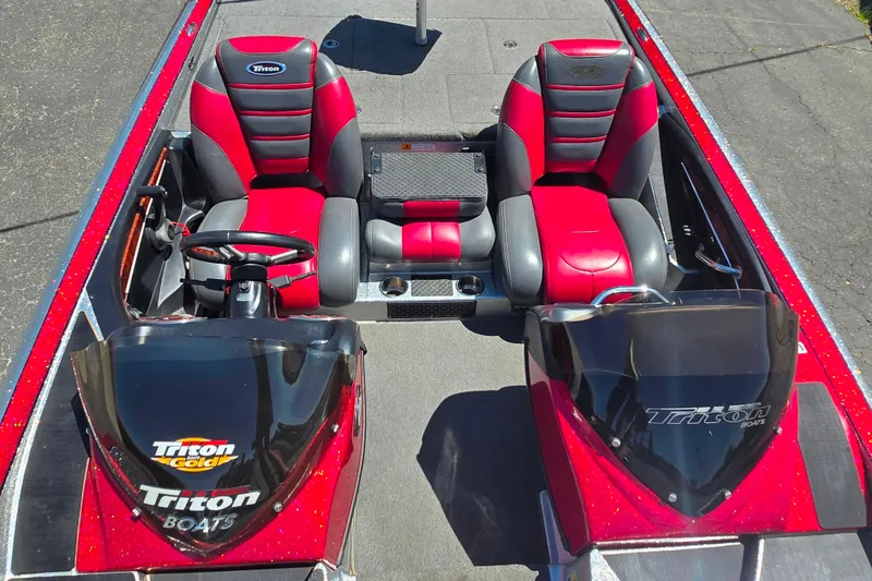 Slide: The Image of 2011 Triton 20XS DC boat interior with red and black seats, dual consoles, and steering wheel. - 12