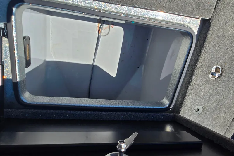Slide: The Image of Open storage compartment in 2011 Triton 20XS DC boat, showcasing interior space. - 13
