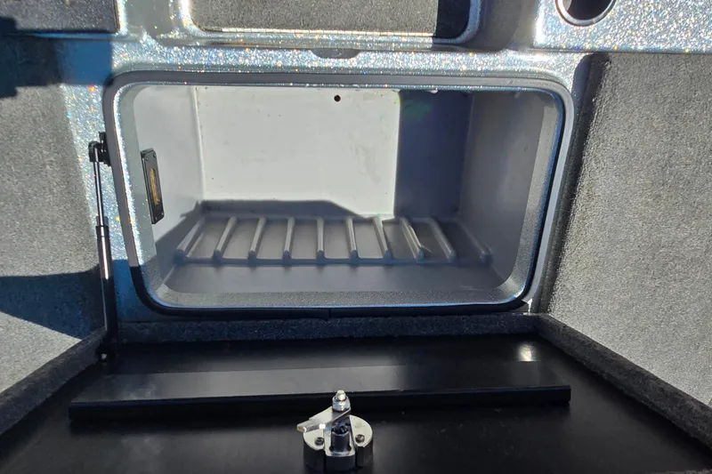 Slide: The Image of Open storage compartment in a 2011 Triton 20XS DC boat. - 14