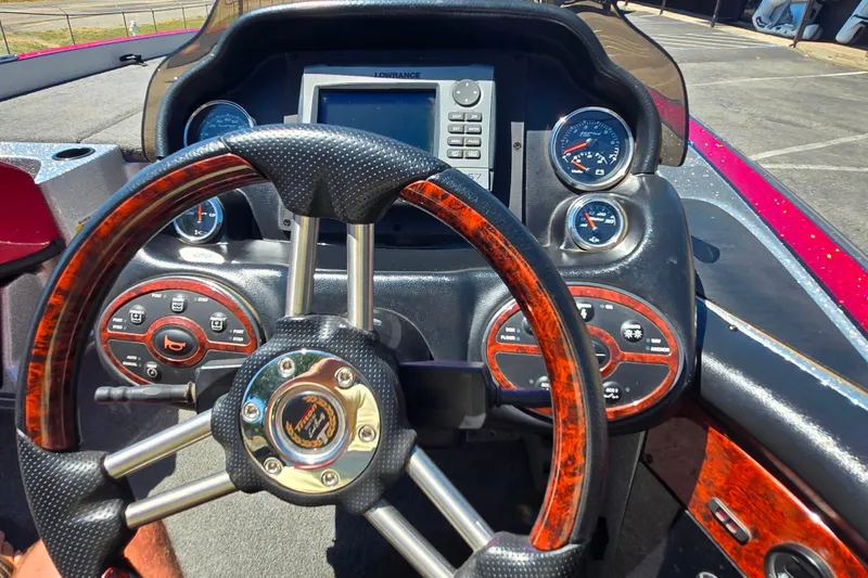 Slide: The Image of Dashboard of a 2011 Triton 20XS DC boat with steering wheel and gauges. - 19