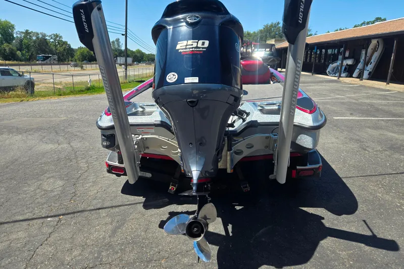 Slide: The Image of 2011 Triton 20XS DC boat with powerful 250 horsepower engine, parked outdoors. - 3