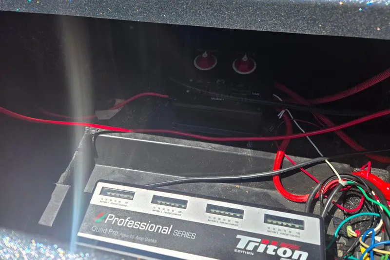 Slide: The Image of 2011 Triton 20XS DC boat battery compartment with Professional Series charger and wiring. - 5