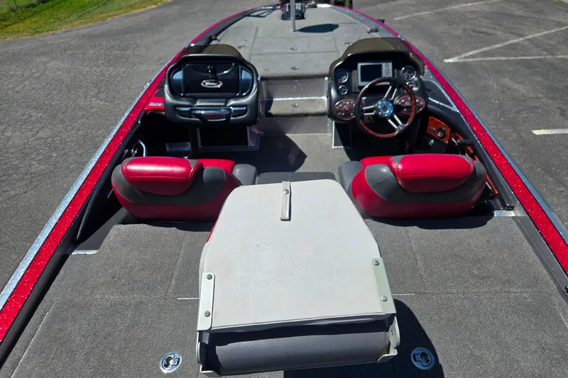 Slide: The Image of 2011 Triton 20XS DC boat interior with red and black seating, steering wheel, and dashboard controls. - 6