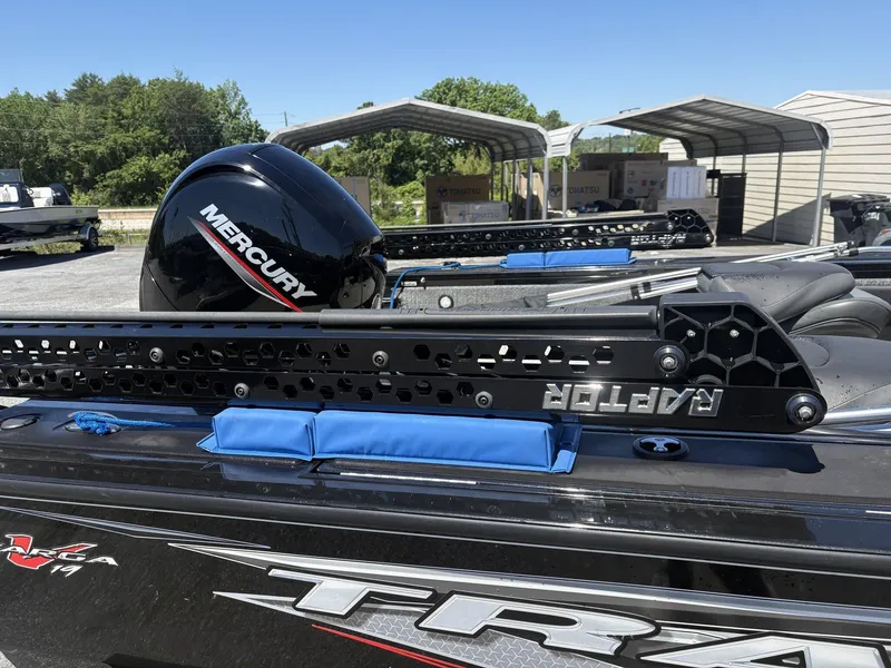 Slide: The Image of 2022 Tracker Targa V19 with Mercury engine, parked outdoors. - 4