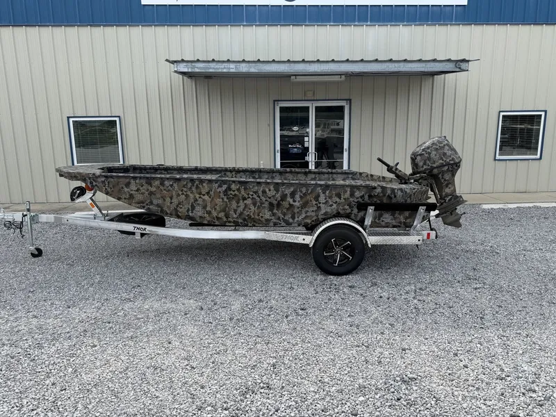 The Image of 2026 Thor Fish Hammer boat with camouflage design and trailer. - 1