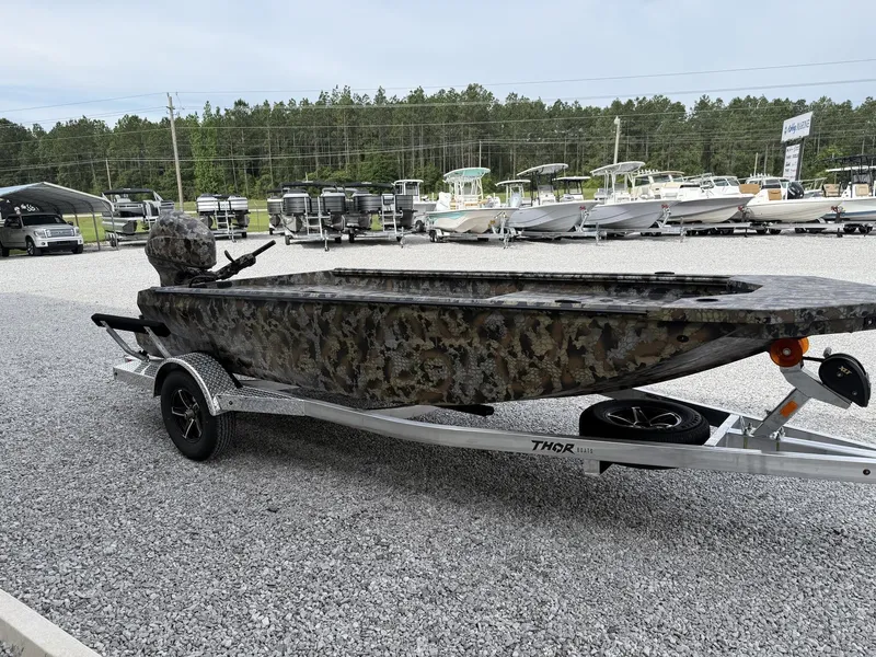 Slide: The Image of 2026 Thor Fish Hammer boat with camouflage design on trailer. - 3