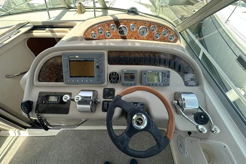 Slide: The Image of Cockpit of 2001 Sea Ray Sundancer 310 with steering wheel and navigation controls. - 5