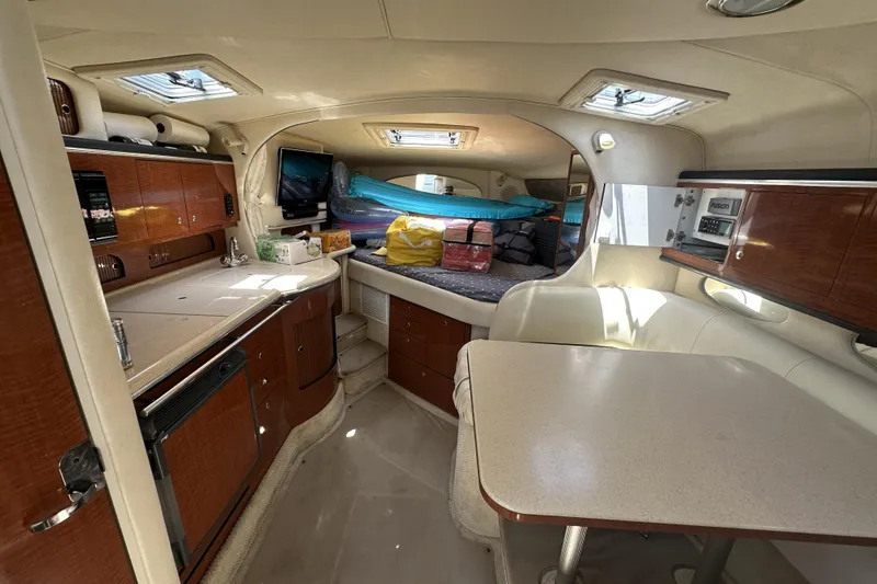 Slide: The Image of Interior of 2001 Sea Ray Sundancer 310 yacht with kitchenette and seating area. - 8