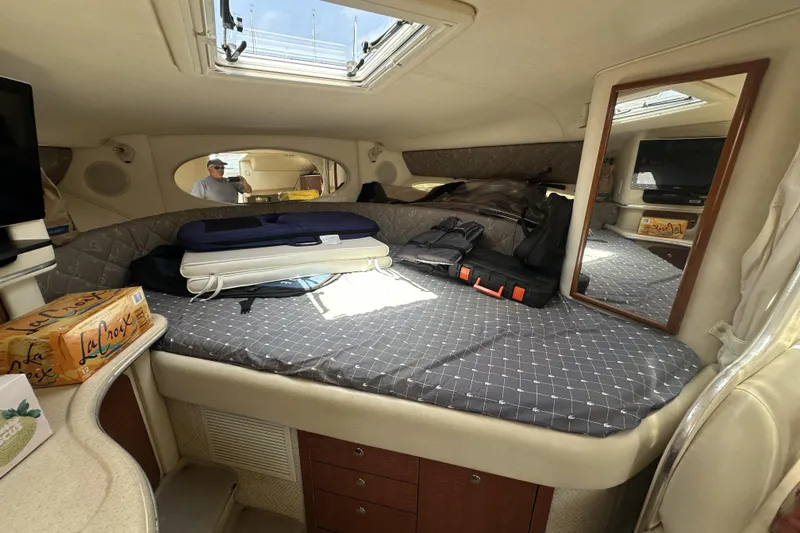 Slide: The Image of Interior cabin of a 2001 Sea Ray Sundancer 310 with bed, mirror, and storage. - 9