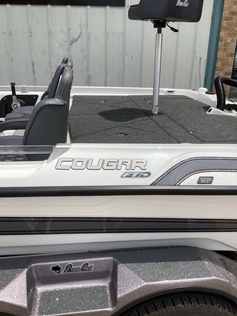 Slide: The Image of 2026 Bass Cat Cougar FTD boat with gray carpeted deck. - 15