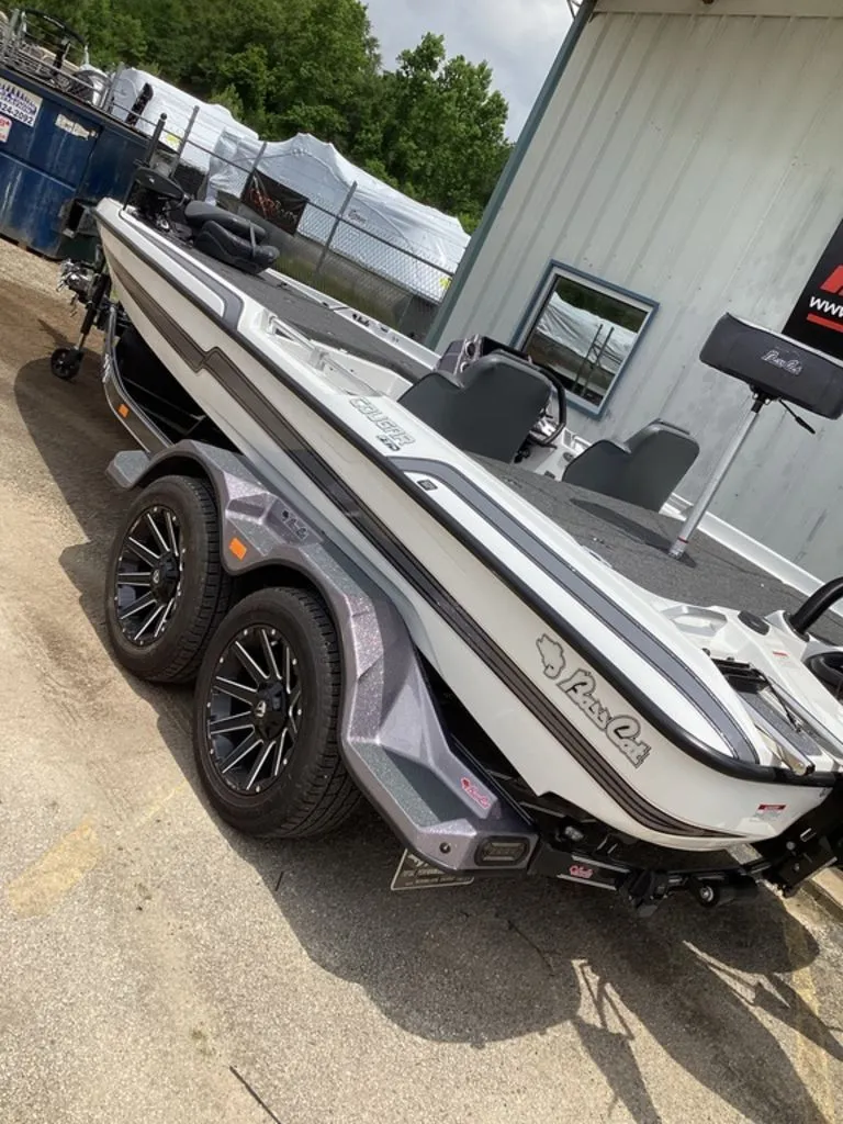 Slide: The Image of 2026 Bass Cat Cougar FTD boat on trailer, side view. - 2