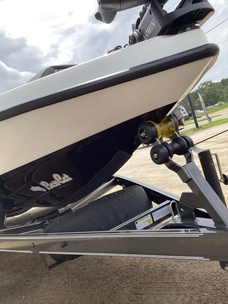 Slide: The Image of 2026 Bass Cat Cougar FTD boat on trailer, close-up view. - 22