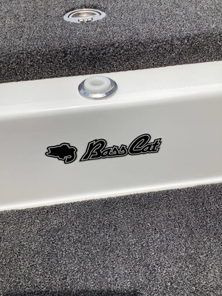 Slide: The Image of 2026 Bass Cat Cougar FTD boat logo on gray carpet. - 49