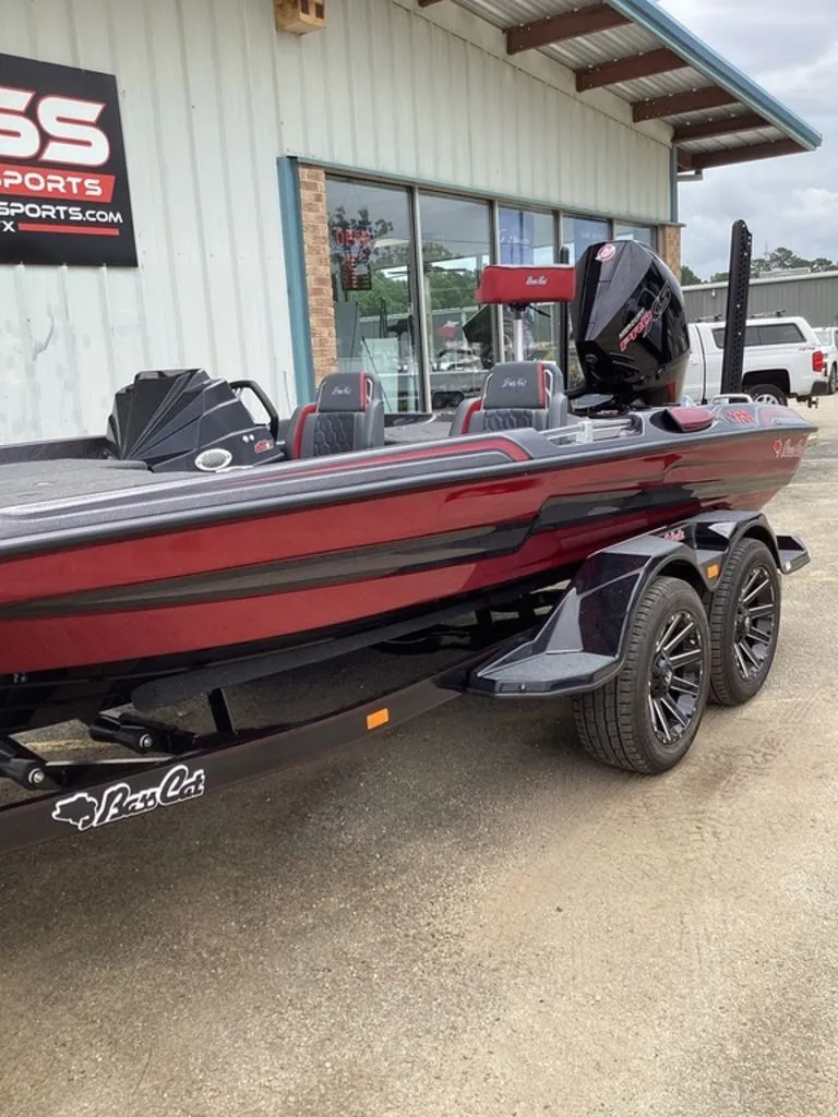 Slide: The Image of 2026 Bass Cat Eyra boat parked outside a store. - 16
