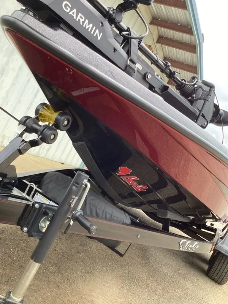 Slide: The Image of 2026 Bass Cat Eyra boat on trailer, Garmin equipment visible. - 19