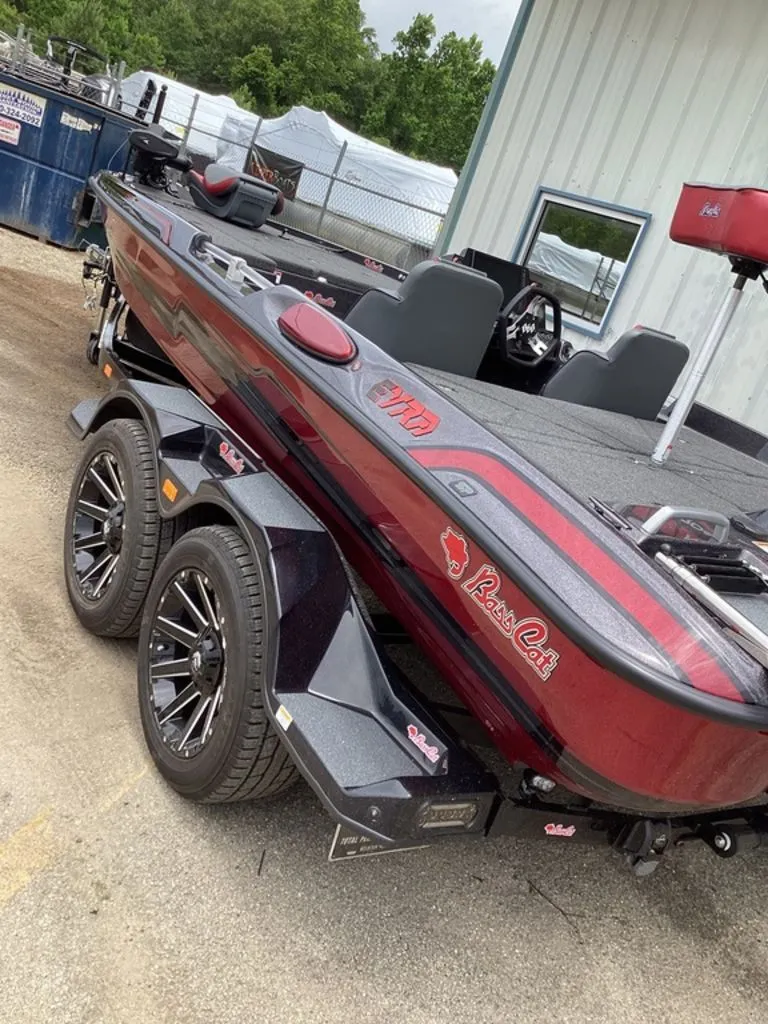 Slide: The Image of 2026 Bass Cat Eyra boat on trailer, red and black, side view. - 2