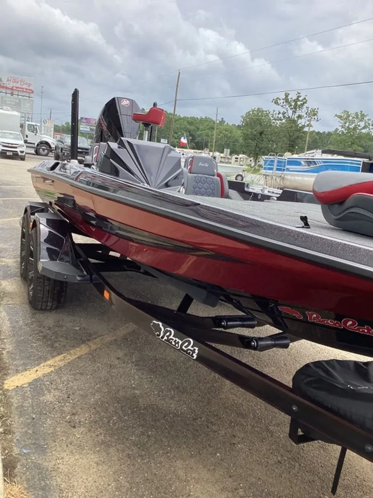 Slide: The Image of 2026 Bass Cat Eyra boat on trailer, red design. - 22