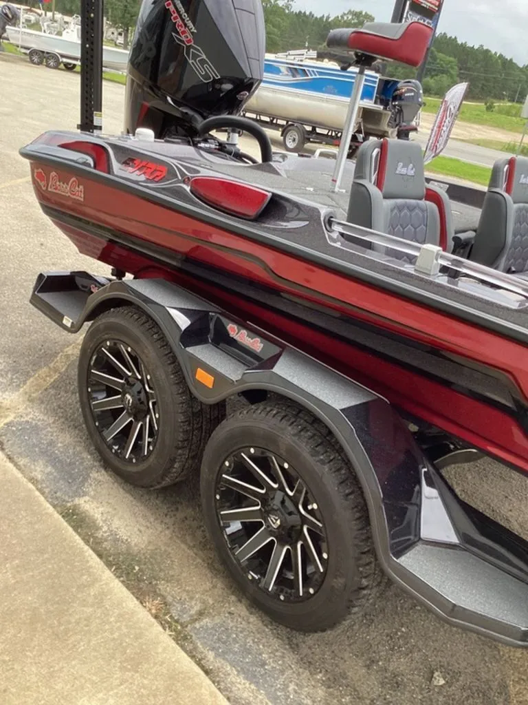 Slide: The Image of 2026 Bass Cat Eyra boat on trailer, red color, modern features. - 26