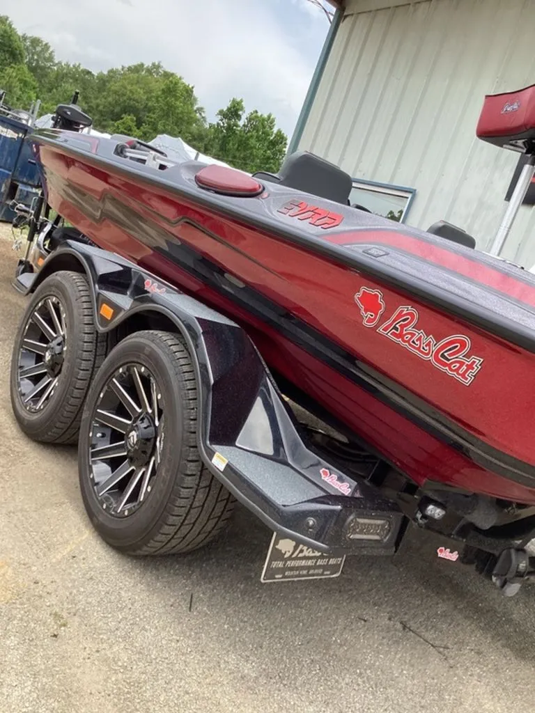 Slide: The Image of 2026 Bass Cat Eyra boat on trailer, red color. - 3