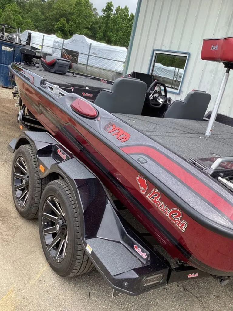 Slide: The Image of 2026 Bass Cat Eyra boat on trailer, red and black, side view. - 9