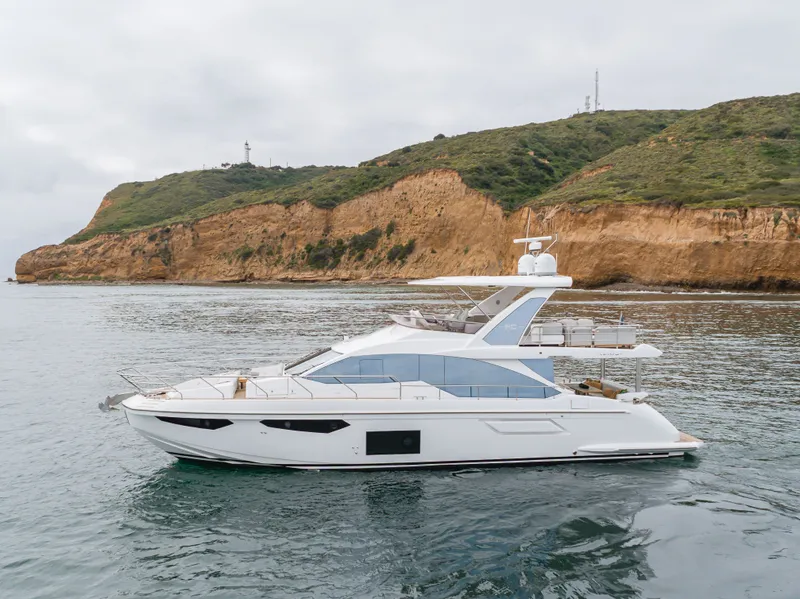 Slide: The Image of 2020 Azimut Fly 60 yacht near rocky coastline. - 16