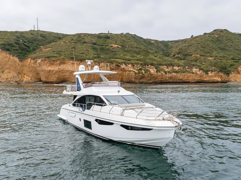 Slide: The Image of Azimut Fly 60 Yacht 2020 near rocky coastline. - 18
