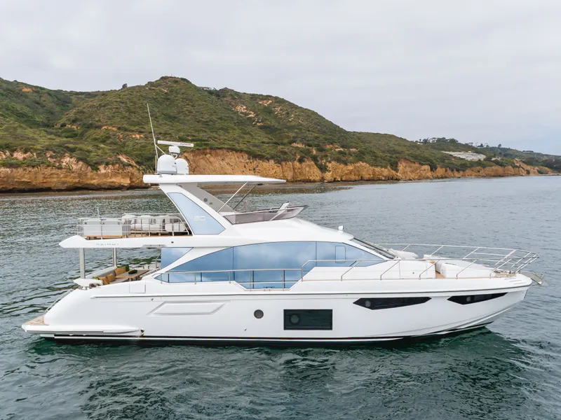 Slide: The Image of 2020 Azimut Fly 60 yacht cruising near scenic coastline. - 22