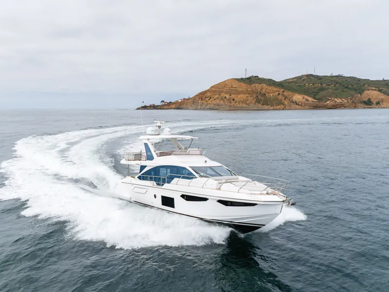 Slide: The Image of Azimut Fly 60 Yacht 2020 cruising near coastal landscape. - 4