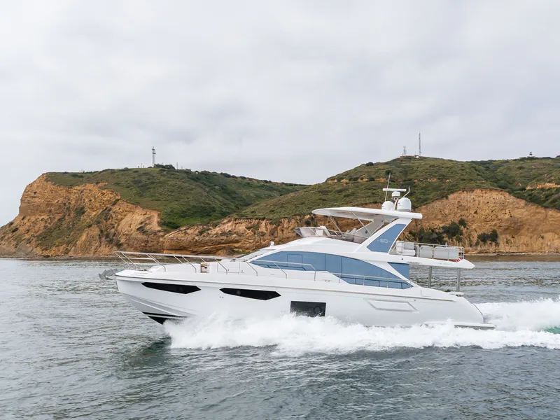 Slide: The Image of Azimut Fly 60 Yacht 2020 cruising near rocky coastline. - 5
