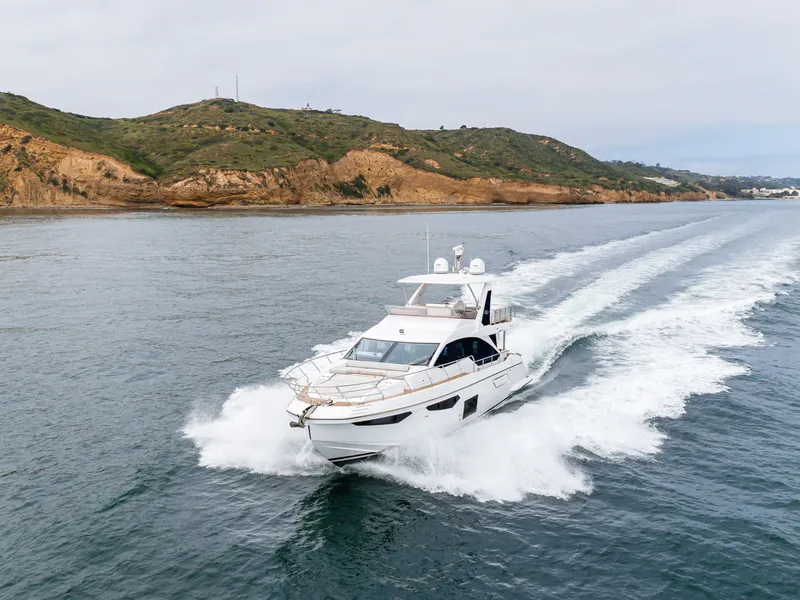 Slide: The Image of Azimut Fly 60 Yacht 2020 cruising on open sea near coastal landscape. - 6
