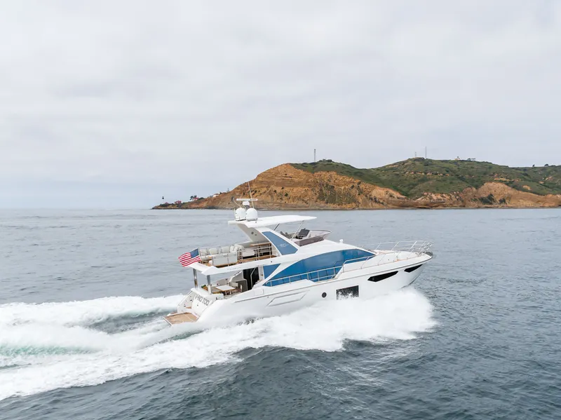 Slide: The Image of 2020 Azimut Fly 60 yacht cruising near a scenic coastline. - 7