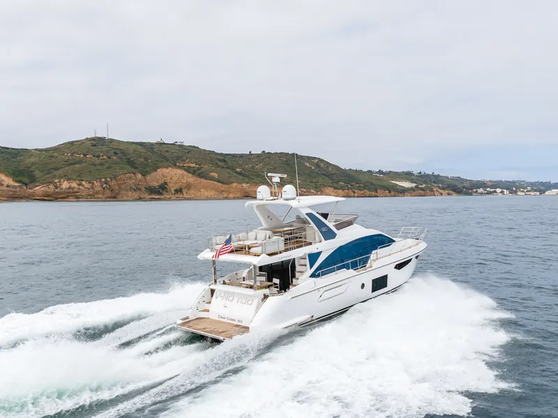 Slide: The Image of Azimut Fly 60 Yacht 2020 cruising on open sea near coastal landscape. - 8