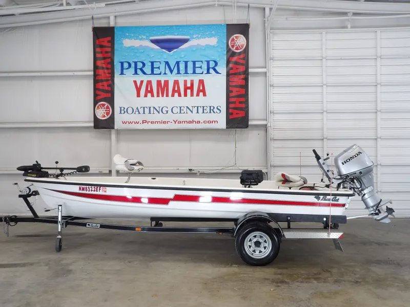 The Image of 2017 Bass Cat Phelix boat with Honda motor in a showroom. - 1