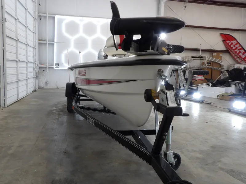 Slide: The Image of 2017 Bass Cat Phelix boat in a garage on a trailer. - 5
