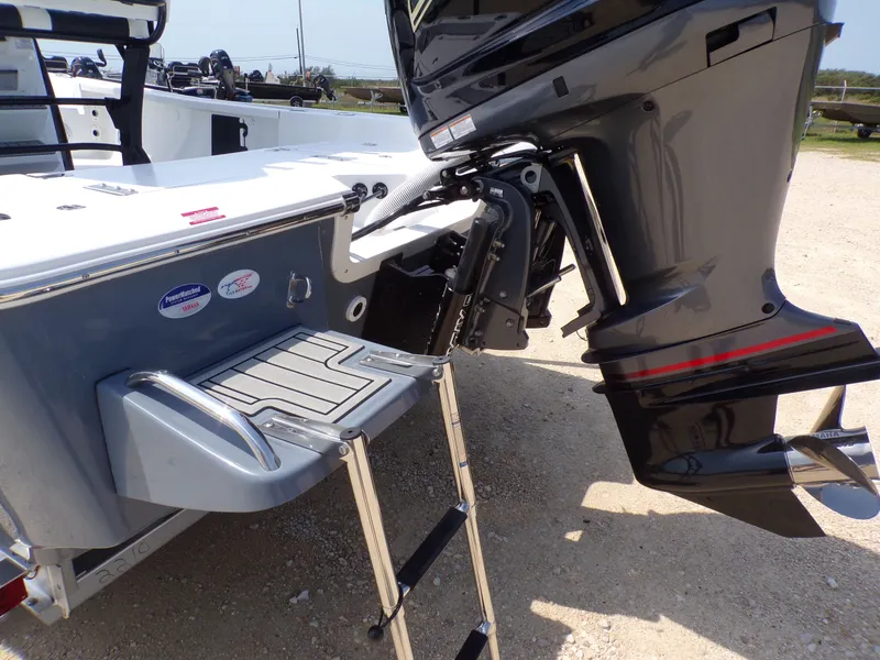 Slide: The Image of 2026 Tidewater 2210 Carolina Bay boat with outboard motor and swim ladder. - 17