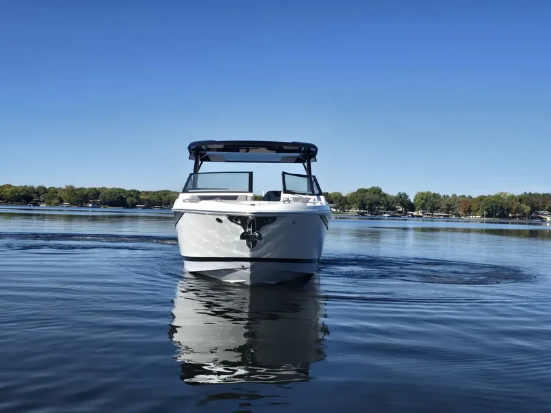 Slide: The Image of Cobalt R35 2025 boat on calm lake under clear sky. - 3